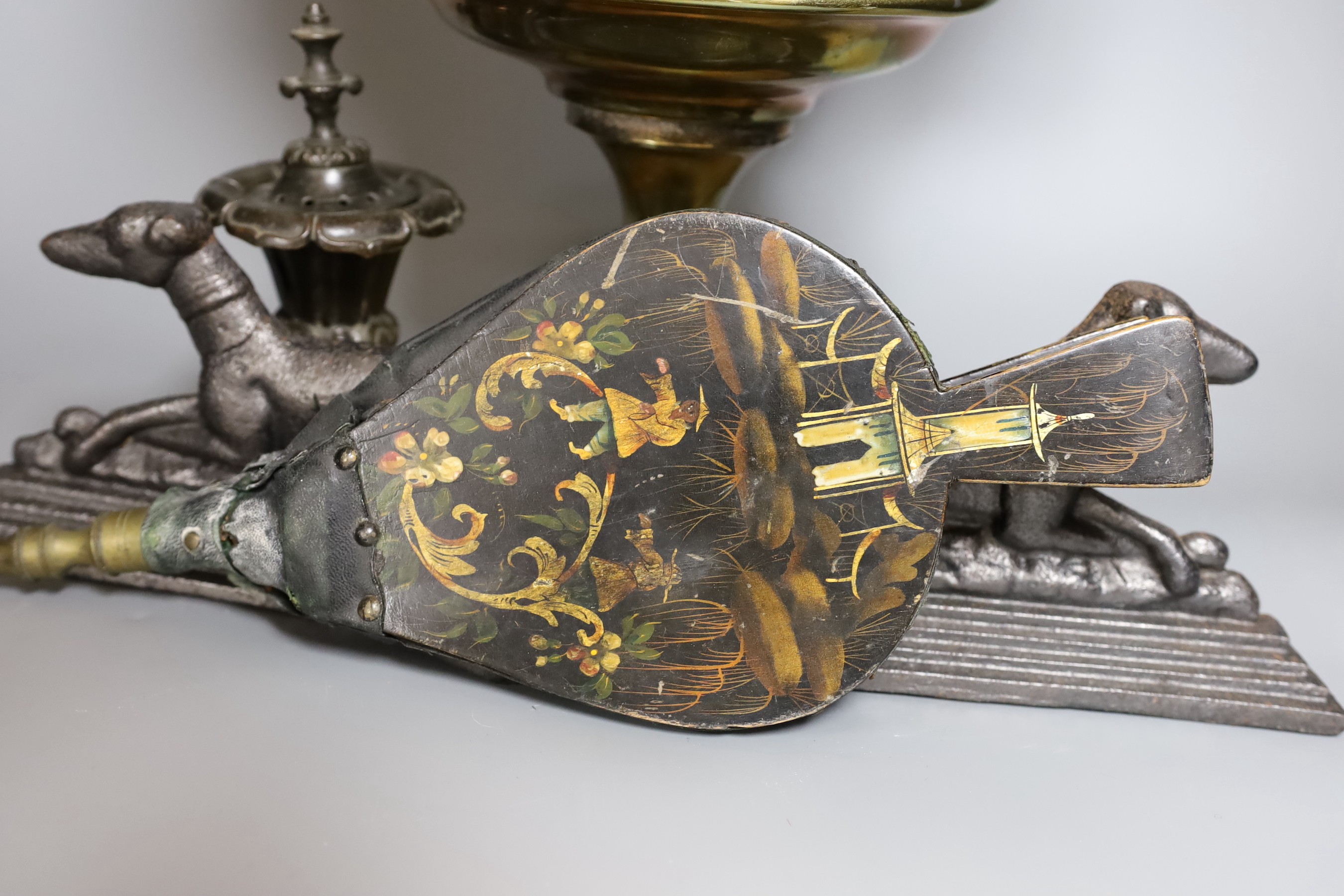 A Victorian copper vase on plinth base, a pair of Victorian cast iron recumbent dog door stops and a Regency bronze censer and cover, and a Victorian lacquered bellow (5)